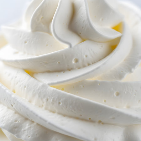 Vanilla ice cream with whipped cream on a white background. Macro.の素材