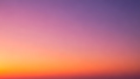 Sunset sky background with tiny clouds. Colorful sunset sky.の素材
