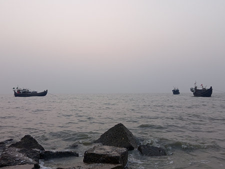 Fishing boats on the sea in the foggy morning. India