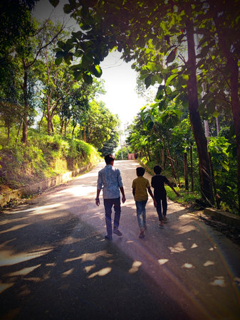 Two boys walking on the road.の写真素材