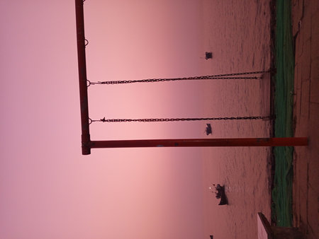 Swing hanging on the wall in the evening.の写真素材