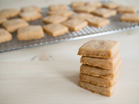 Freshly baked shortbread cookies on a table and cooling rackの写真素材