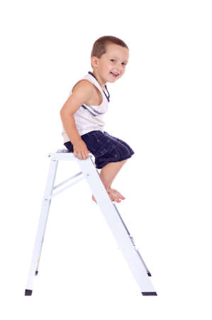 Cute little boy climbing on a stepladderの写真素材