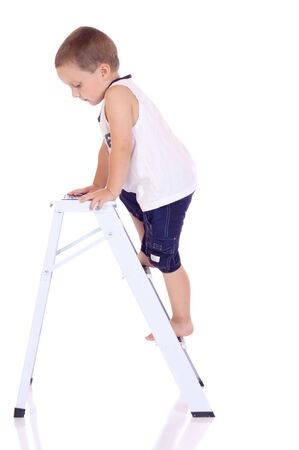 Cute little boy climbing on a stepladderの写真素材