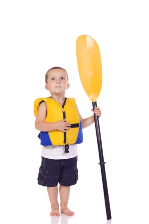 Cute little boy with a life jacket and a paddleの写真素材