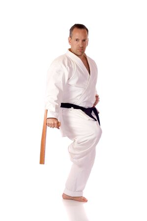 Man in karate-gi holding a pair of tonfaの写真素材