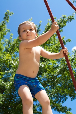 Little boy playing on ropesの写真素材