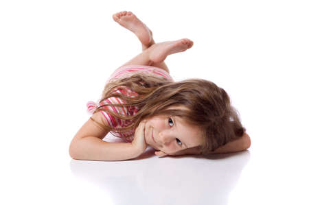 Cute little girl laying on her stomachの写真素材