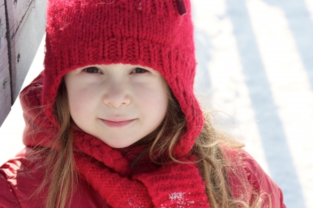 Cute little girl walking in the snowの写真素材