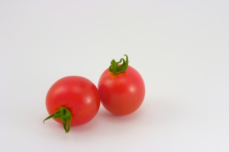 Cherry tomatoes on a white backgroundの写真素材