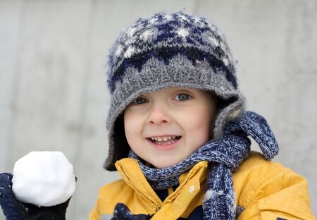 Cute little boy playing in the snowの写真素材