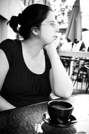 Woman having a coffee outside a restaurantの写真素材