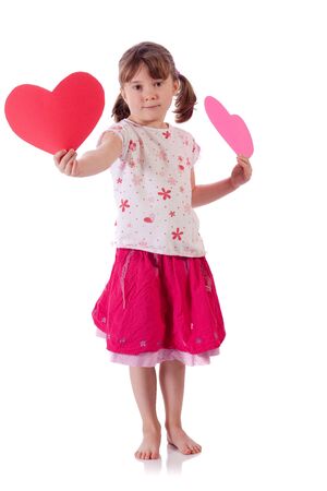 Cute little girl holding two heartsの写真素材
