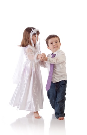 Cute little boy and girl dancing togetherの写真素材