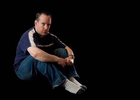 Depressed man on black backgroundの写真素材