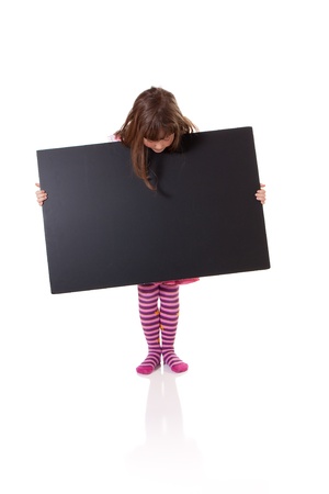 Cute little girl holding a blank cardboard signの写真素材