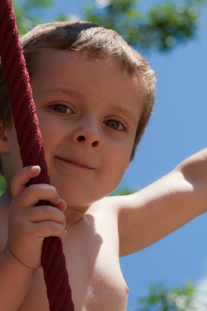 Little boy playing on ropesの写真素材