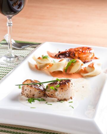 Roasted scallops, pasta and shrimpの写真素材