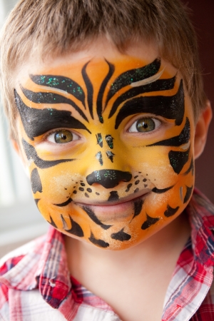 Cute little boy with a tiger make-upの写真素材