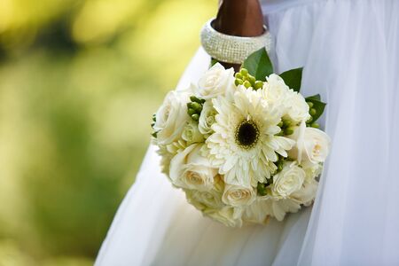 Black woman holding a wedding bouquetの写真素材