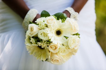 Black woman holding a wedding bouquetの写真素材