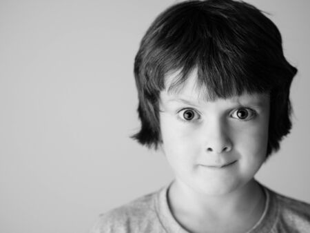 Funny little boy looking doubtful