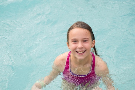 Smiling girl in a swimming poolの写真素材