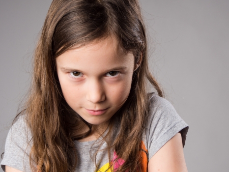 Stubborn little girl in studioの写真素材