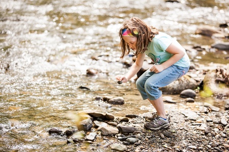 Girl playing near the riverの写真素材