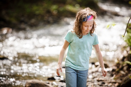 Girl playing near the riverの写真素材