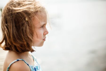 Thoughtful girl on a warm and windy summer dayの写真素材