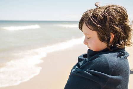 Boy standing on the beach and relaxing in Cape Codの写真素材