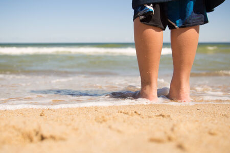 Boy standing on the beach and relaxing in Cape Codの写真素材