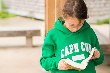 Girl reading near the beach in Cape Codの写真素材