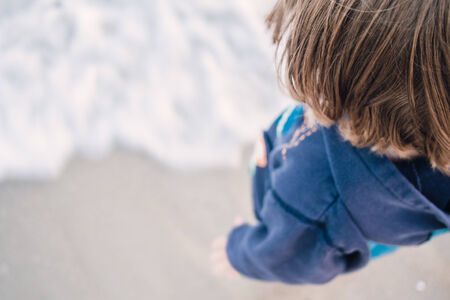Boy standing on the beach and relaxing in Cape Codの写真素材