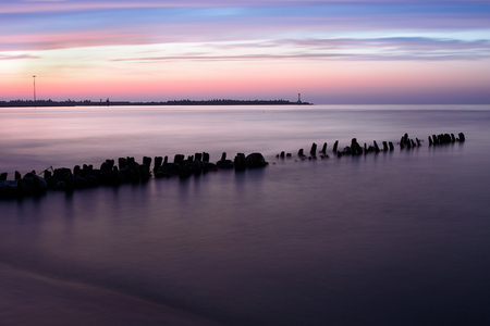 The quiet sea and calm. A beautiful decline and a lighthouse in the background.の写真素材
