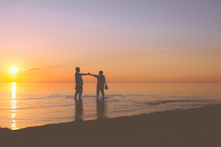Senior couple walking at sunset