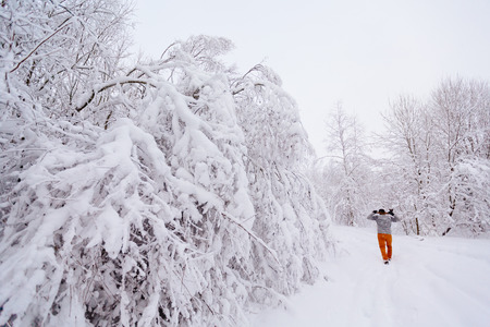 Lumberjack walks in a snowy forestの写真素材