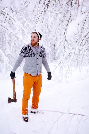 Lumberjack in the snowy winter forestの写真素材