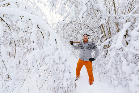 Lumberjack in the snowy winter forestの写真素材