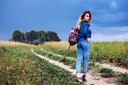 Beautiful fashionable girl with a backpackの写真素材
