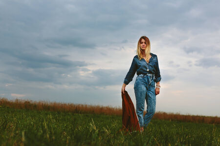 Beautiful girl holding a jacketの写真素材