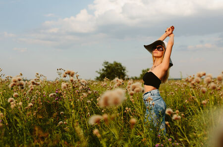 Beautiful girl in hat and sunglassesの写真素材