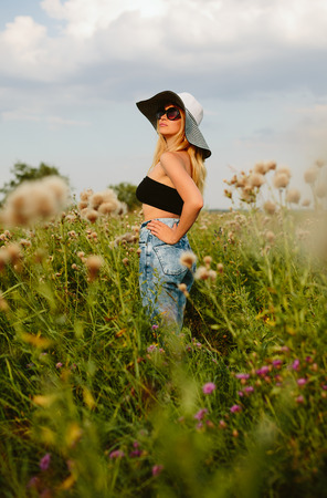 Beautiful girl in hat and sunglassesの写真素材