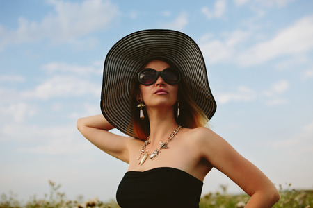Beautiful girl in hat and sunglassesの写真素材