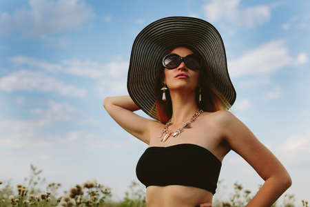 Beautiful girl in hat and sunglassesの写真素材