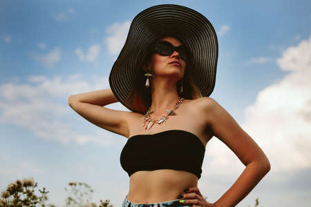 Beautiful girl in hat and sunglassesの写真素材