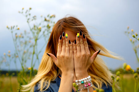 Girl covers her face with her handsの写真素材