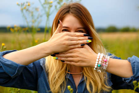 Girl covers her face with her handsの写真素材