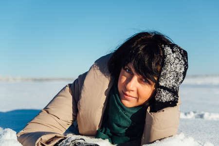 girl lying on the snowの写真素材